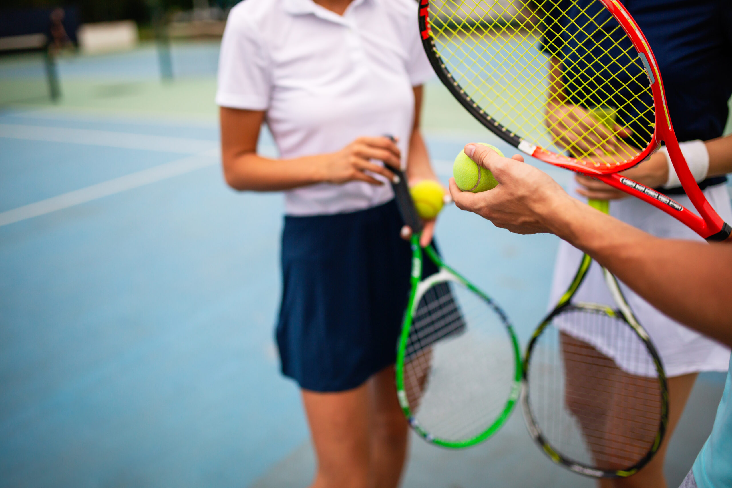 Portrait of fit happy women playing tennis together. People sport healthy lifestyle concept